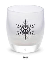 Load image into Gallery viewer, A white glassybaby votive with a hand etched snowflake and heart design, with the year 2026 visible at the bottom of the image.