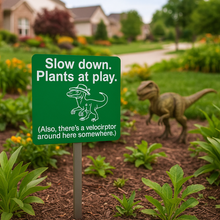 Load image into Gallery viewer, Velociraptor Garden Sign – “Slow Down, Plants at Play” – Laser Engraved Dinosaur Yard Stake