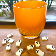 Load image into Gallery viewer, Orange votive holder is dispayed on a wooden windowsill with white acrylic ghosts table scatter.
