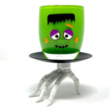 Load image into Gallery viewer, Whimsical iconic monster wt hed and painted on a green votive.
